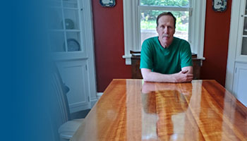 Dr. Ike Eisenlohr with the cherry dining table he made